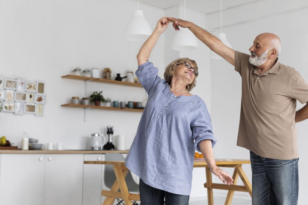 Elderly couple dancing in kitchen